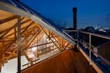 Outdoor, Small Patio, Porch, Deck, and Rooftop A staircase leads up to the second level.  Photo 15 of 17 in This Whimsical Home in Japan Encourages Play and Exploration