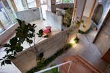 Hallway and Concrete Floor Low walls were built along the entrance area of the house, to create an internal “alley” that separates the two studio spaces.  Photo 6 of 17 in This Whimsical Home in Japan Encourages Play and Exploration