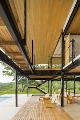Outdoor, Front Yard, Lap Pools, Tubs, Shower, Large Patio, Porch, Deck, Grass, Wood Patio, Porch, Deck, and Trees The outdoor dining and lounge area flows out toward the pool.

  Photos from Moveable Walls Amplify Sublime Views For This Costa Rican Home