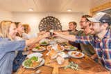 The three couples behind Tiny Heirloom enjoy a meal together.  Photo 4 of 20 in This Oregon Company Crafts Exceptional Tiny Homes Starting at $40K