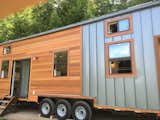 This vacation home for a family of four in the Rocky Mountains has rustic reclaimed hardwood floors, and salvaged beetle kill pine boards on the ceiling to complement its rugged mountain setting.  Photo 11 of 20 in This Oregon Company Crafts Exceptional Tiny Homes Starting at $40K