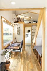 A handcrafted, fold-up dining table/desk made from walnut with white oak inlays, and a built-in reading nook with storage, make good use of space.  Photo 8 of 20 in This Oregon Company Crafts Exceptional Tiny Homes Starting at $40K
