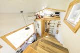 This tiny home has a fully tiled shower and a traditional staircase leading up to the master loft. An additional guest loft is accessible via a metal built-in ladder.  Photo 7 of 20 in This Oregon Company Crafts Exceptional Tiny Homes Starting at $40K