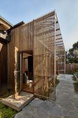 Doors, Exterior, Swing Door Type, and Wood A new addition with a steel structure clad in hardwood screens was created at the rear of the house.   Photo 3 of 17 in Wooden Screens Shade This Sustainable Melbourne Residence