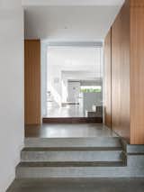 Hallway and Concrete Floor Internal brick walls and polished concrete surfaces provide thermal mass that help keep the interior spaces cool.  Photo 5 of 11 in A Sleek Australian Dwelling Keeps its Cool With Passive Design