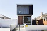 Exterior, Metal, House, Brick, Metal, and Flat The home presents a narrow facade to the street.  Exterior Metal House Flat Brick Photos from A Sleek Australian Dwelling Keeps its Cool With Passive Design