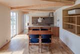Dining Room, Pendant Lighting, Chair, Light Hardwood Floor, Table, and Shelves Half of the house is a solid volume with a shed roof.   Photos from This Dreamy Japanese Abode Is Part Greenhouse