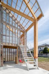 The greenhouse structure is clad entirely in translucent acrylic glass.