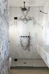 The two bathrooms feature gorgeous Carrara marble wall tiles.