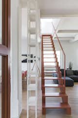 The pink staircase links the common areas in the lower level with the master bedroom above.