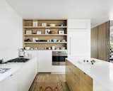 A streamlined modern kitchen with white cabinetry.