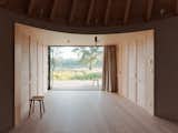 Hallway and Light Hardwood Floor The large, rectangular entrance frames idyllic views of the surrounding countryside.  Photo 5 of 13 in This Serene Cabin in Slovakia Takes the Shape of a Yurt
