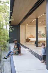 Outdoor, Small Patio, Porch, Deck, Front Yard, and Trees The SysHaus construction method reduces water and resource wastage from the traditional construction process.  Photos from This Eco-Minded Home in São Paulo Raises the Bar For Prefab