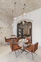 Living Room, Chair, Pendant Lighting, Terrazzo Floor, and Table Manca Studio hired skilled workers with experience in historical restoration to recover the cave dwellings and repurposes the chambers into comfortable and elegant public areas and four intimate and romantic suites.  Photo 6 of 16 in Stay in This Extraordinary Cave Hotel in Southern Italy