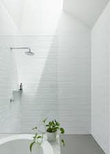 Bath Room, Open Shower, Drop In Tub, and Ceramic Tile Wall The ceramic tiles were created with irregular glaze, which mimics the reflections of the harbor nearby.   Search “kitchenbacksplashes--ceramic-tile” from A Renovation Sheds New Light on a Cookie-Cutter Home in Sydney