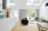 Living Room, Coffee Tables, End Tables, Sofa, Chair, Light Hardwood Floor, Wall Lighting, Pendant Lighting, and Rug Floor  Photo 1 of 8 in H O U S E S by Antonella Luchetti from A Renovation Sheds New Light on a Cookie-Cutter Home in Sydney