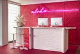 In the concierge section of the open-air lobby is a neon pink wall with "Aloha" neon signage.&nbsp;