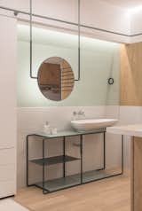 The light, clean profile of the vanity gives the bathroom a sense of spaciousness and modernity.