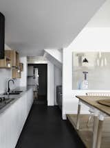 Kitchen, Drop In Sink, Cooktops, White Cabinet, and Wall Lighting A fridge, laundry area, and office desk are incorporated into the butler’s pantry.

  Photo 5 of 14 in A Melbourne Home Is Treated to a Striking Barn–Like Extension