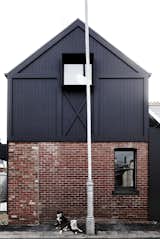 Exterior, Metal Siding Material, House Building Type, Gable RoofLine, Brick Siding Material, and Metal Roof Material "We liked the idea of capturing the informality of a holiday place—nothing precious, all simple and practical," explain the architects.

  Photo 2 of 14 in A Melbourne Home Is Treated to a Striking Barn–Like Extension