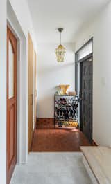 Hallway and Terra-cotta Tile Floor Some of the original 1980s tiles and joinery were retained to give the updated house a hint of retro flavor.  Photos from Budget Breakdown: A Tired ’80s Home in Japan Gets a Bright Remodel For $164K