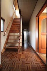 Staircase, Wood Tread, and Wood Railing Before: the entrance foyer and stairs.  Photo 4 of 20 in Budget Breakdown: A Tired ’80s Home in Japan Gets a Bright Remodel For $164K