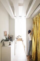 Along one side of the entrance hall is the kitchen that can be concealed with a funky, gold metallic curtain made from an isothermal emergency blanket.