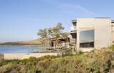 Exterior, House, Concrete, Metal, Flat, Wood, and Shed The roofs are made of corrugated aluminum, and the timber sidings used at the entrance are repeated on key ceiling planes.

  Exterior Metal House Flat Shed Concrete Photos from An Elegant South African Home Embraces Mesmerizing Views