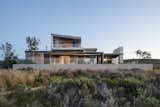 Exterior, House, Metal, Concrete, Wood, Flat, and Shed The owner wanted a cozy family escape with plenty of outdoor entertaining areas.

  Exterior Metal Flat Shed Concrete Photos from An Elegant South African Home Embraces Mesmerizing Views