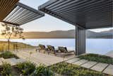 Outdoor, Walkways, Large, Shrubs, Slope, Wood, Side Yard, and Gardens Robust and low-maintenance metal mesh—which offers both solar and privacy control—has been chosen for the screens.  

  Outdoor Side Yard Slope Walkways Photos from An Elegant South African Home Embraces Mesmerizing Views