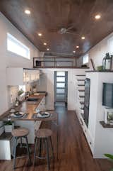 Dining Room, Stools, Recessed Lighting, and Dark Hardwood Floor The trio, who are presently completing their tenth custom-built tiny house, approach their work with a great deal of empathy for their clients.  Photo 2 of 19 in This Canadian Trio Builds Contemporary Tiny Homes Starting Under $69K