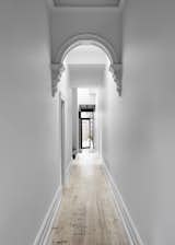 Hallway and Light Hardwood Floor A look at one of the restored stucco arches along the ceiling of the hallway.

  Photo 5 of 19 in A Historic Melbourne Home Is Respectfully Modernized For a Young Family