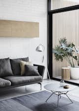 Living Room, Sofa, Coffee Tables, Floor Lighting, Concrete Floor, and Rug Floor Most of the furniture items were sourced from Melbourne furniture retailer Luke Furniture.  

  Photo 7 of 19 in A Historic Melbourne Home Is Respectfully Modernized For a Young Family
