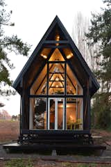 This elevated prefab cabin along the Chilean Andes has a buffer zone that helps protect it against harsh climatic conditions. The 1,033-square-foot Casa R opens up to a "chiflonera," an intermediate space between the interior and exterior commonly found in Patagonian homes.
