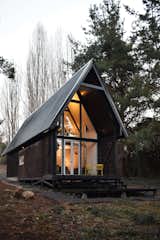 Exterior, A-Frame, Prefab, Small Home, House, Wood, Metal, and Cabin The chiflonera leads to the entrance of the cabin.  Exterior Small Home Wood A-Frame Photos from A Patagonian Prefab Cabin Is Built to Withstand Volatile Climates