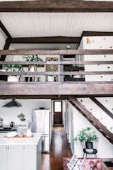 New York City–based couple Danielle and Ely Franko share the renovation budget for the Hunter Greenhouse, a 1971 Catskills home that they purchased in 2016 and now rent out as a snug holiday home. The house has two levels, and a lofted lounge in the front section of the upper floor.