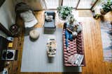 Living Room, Ottomans, Coffee Tables, Sofa, End Tables, Medium Hardwood Floor, and Chair The Hunter Greenhouse is a warm and stylish holiday retreat in the Catskills.  Photos from Budget Breakdown: Weekend DIYers Renovate a Dated Catskills Retreat For $201K