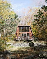 Exterior, House Building Type, Wood Siding Material, and Flat RoofLine The exterior of the Hunter Greenhouse before the renovation.  Photo 7 of 21 in 7 Unbelievable Rustic Cabin Makeovers from Budget Breakdown: Weekend DIYers Renovate a Dated Catskills Retreat For $201K