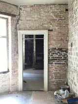 Inside, the old brick walls were kept intact and painted gray in certain sections.

  Photo 3 of 16 in Before & After: A Little Flat in Ukraine Gets a Modern Upgrade