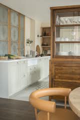 Kitchen, Cement Tile Floor, and Wood Cabinet The original stained glass was retained in the kitchen.

  Photos from A 1930s Barcelona Apartment Is Revitalized Into an Airy Abode