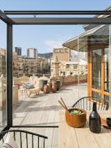 Outdoor, Large Patio, Porch, Deck, and Rooftop Wood vases on the roof deck by Meritxell Ribé-The Room Studio.

  Photo 8 of 15 in A 1930s Barcelona Apartment Is Revitalized Into an Airy Abode