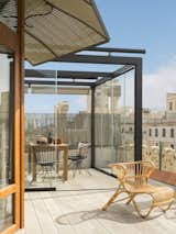 Outdoor, Large Patio, Porch, Deck, and Rooftop An armchair by Teodora Exteriorismo on the roof deck.

  Photos from A 1930s Barcelona Apartment Is Revitalized Into an Airy Abode