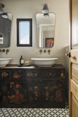 Bath Room, Wood Counter, Cement Tile Floor, and Vessel Sink This antique cabinet was also used in the original property.

  Photos from A 1930s Barcelona Apartment Is Revitalized Into an Airy Abode