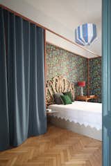 Here is a look at a rattan headboard by Maison du Monde, and a metallic frame wardrobe designed by Marcante-Testa, with a curtain by Kvadrat. The Suzie pedant lamp is by Colonel.