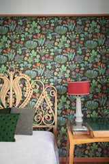 In this room, the wallpaper is by Svenskt Tenn, and the table lamp is by Servomuto.
