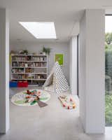 Kids Room, Playroom Room Type, Bookcase, and Toddler Age A children's playroom on the ground floor.  Photo 9 of 16 in A Grass-Topped Addition in England Connects Home and Garden