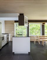 Kitchen, Refrigerator, Wall Oven, Cooktops, Drop In Sink, and White Cabinet A look at the simple, modern kitchen.  Photos from Two Rectangular Volumes Unite to Form a Colorful Lakeside Cabin