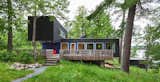 Exterior, Wood Siding Material, Cabin Building Type, Flat RoofLine, and House Building Type  Photo 1 of 15 in Two Rectangular Volumes Unite to Form a Colorful Lakeside Cabin