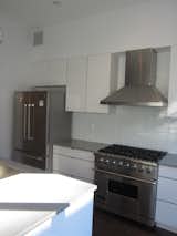 Before: The original kitchen had uninspired, standard finishes.