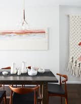 A zinc topped table from Restoration Hardware; lighting fixtures (wrapped in leather) from Pelle; painting on the wall is by Roman painter Giancarlino Benedetti Corcos; large scale wall weaving by Maeve Pacheco;  a mix of vintage pottery from Paul McCobb, Ben Seibel, and Eva Zeisel.


